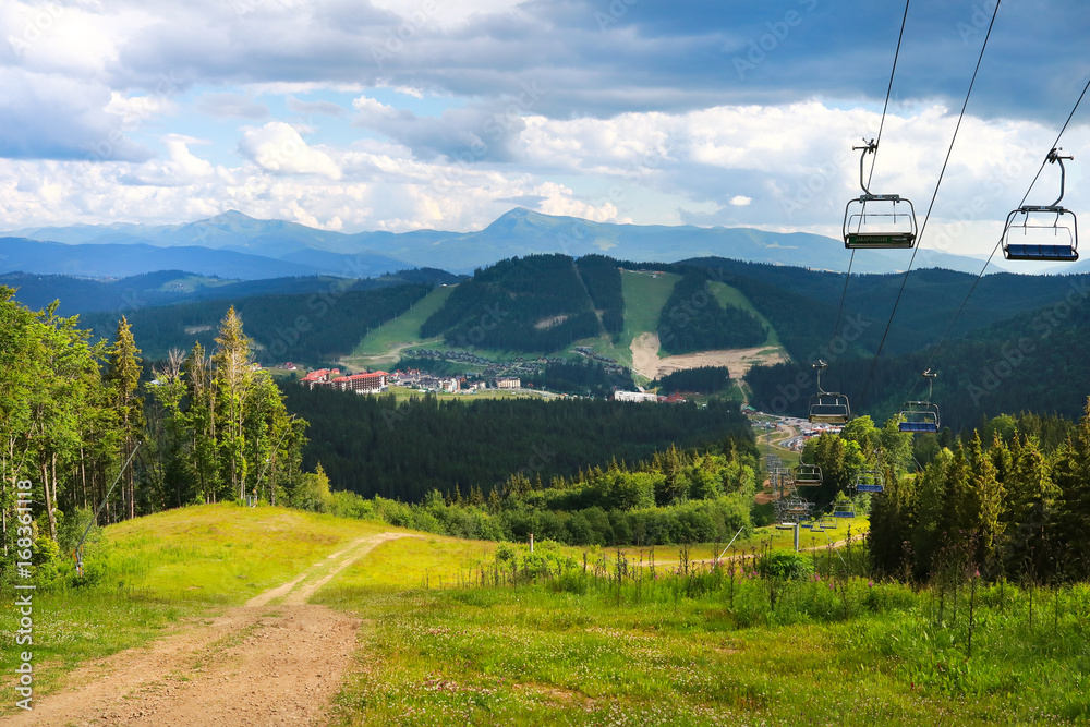 summer view of Carpathian Mountains landscape in Bukovel, Ukraine. Green forests, hills, grassy meadows and blue sky. summer view of Carpathian Mountains landscape in Bukovel, Ukraine. Green forests, hills, grassy meadows and blue sky.