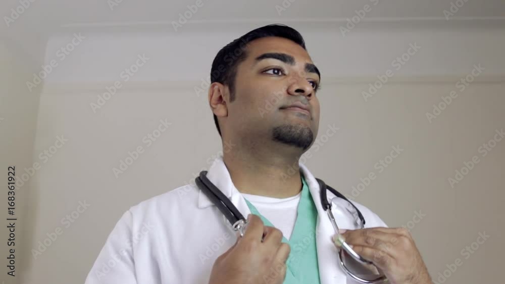 Attractive doctor putting stethoscope around neck Stock Video Adobe Stock