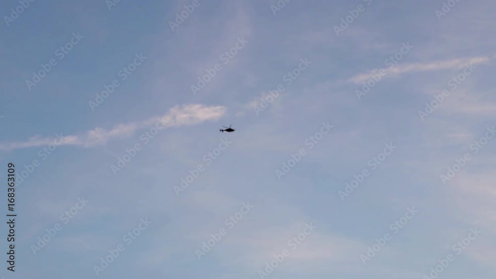 helicopter flying against blue sky and clouds helicopter flying against blue sky and clouds