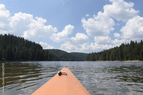 Deck of kayak and horizon of alpine lake