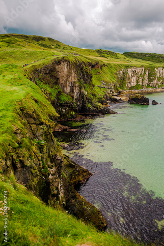 Landscape of Northern Ireland. Cliffs os Carrick-a-rede rope bridge in Ballintoy, Co. Antrim. Traveling through the Causeway Coastal Route.