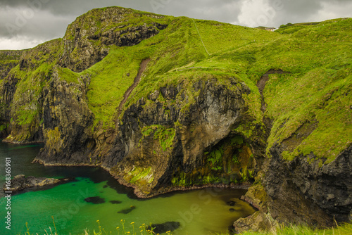 Landscape of Northern Ireland. Cliffs os Carrick-a-rede rope bridge in Ballintoy, Co. Antrim. Traveling through the Causeway Coastal Route.