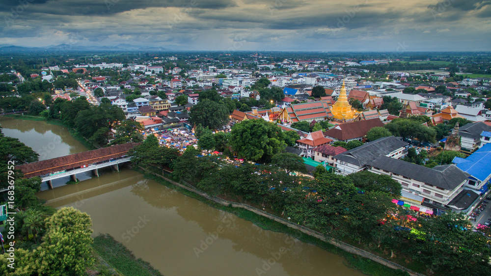 Aerial view lamphun city and People walking on lamphun walk street or night market. tourist attraction in lamphun