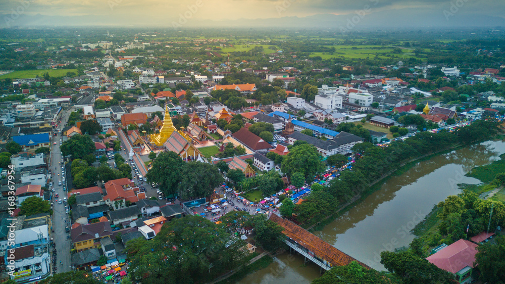 Aerial view lamphun city and People walking on lamphun walk street or night market. tourist attraction in lamphun