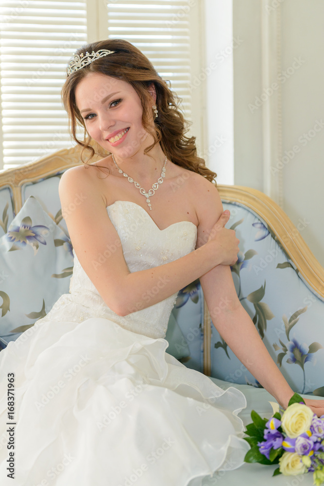 Young attractive bride on wedding gown in studio Young attractive bride on wedding gown in studio