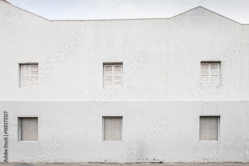 White cement wall with old windows in chaintown, Singapore