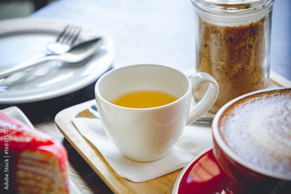 tea cup and coffee and cake on wood table in restaurant. tea cup and coffee and cake on wood table in restaurant.
