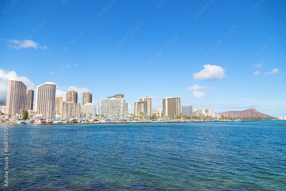 Honolulu cityscape with Diamond Head mountain in a view, Hawaii, USA. A view on Honolulu from the bay in early morning.