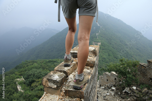 successful woman hiker enjoy the view on the top of great wall