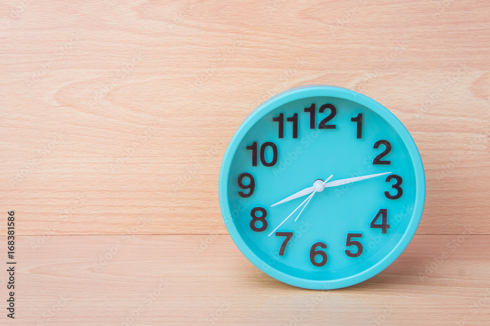 Green clock on wood background , Clock to tell time Create a plan to manage the hustle of life or work. Green clock on wood background , Clock to tell time Create a plan to manage the hustle of life or work.