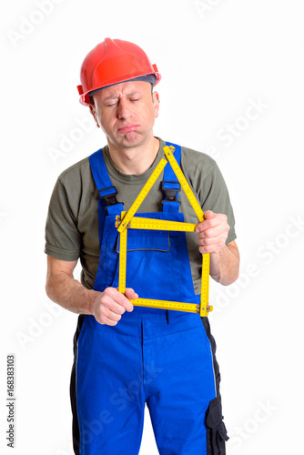 dissatisfied worker with yardstick- house