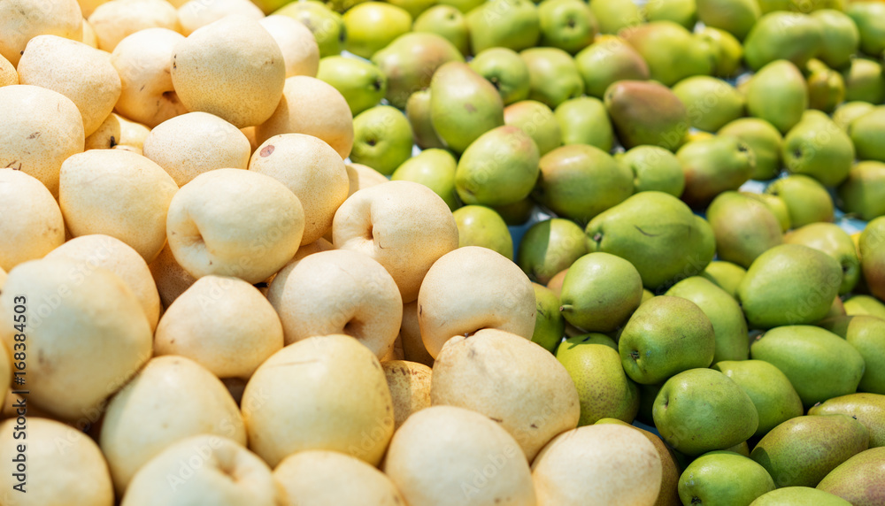 Bunch of green pears on boxes in supermarket Bunch of green pears on boxes in supermarket