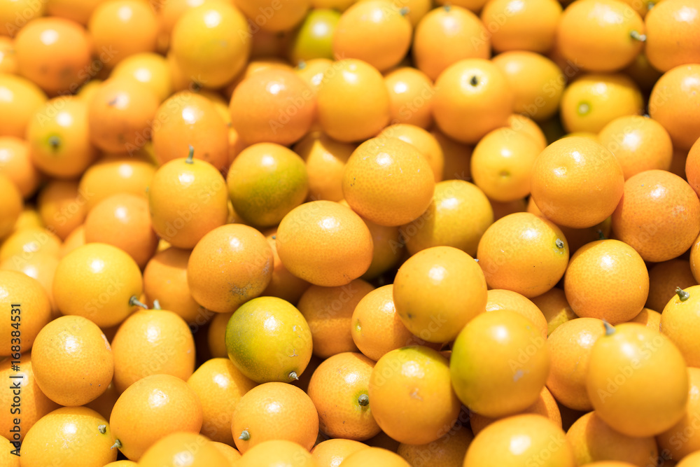Pile of fresh fruit kumquat on a dark table Pile of fresh fruit kumquat on a dark table