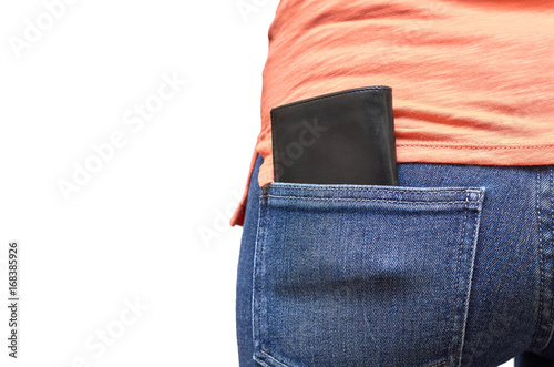 Leather wallet in the pocket of blue jeans. Isolated on white background