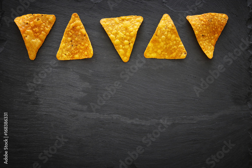 Image of tortilla thips or nachos on slate stone plate photo