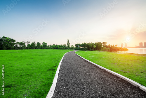 Landscape in city park with lake on sunset