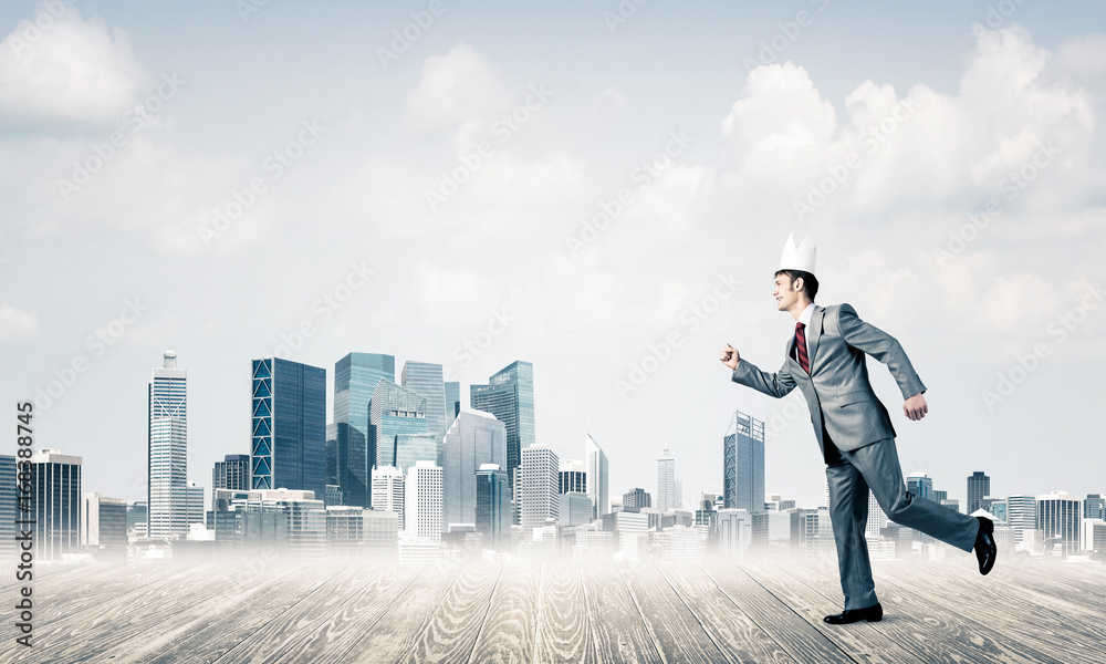 King businessman in elegant suit running and modern cityscape at King businessman in elegant suit running and modern cityscape at