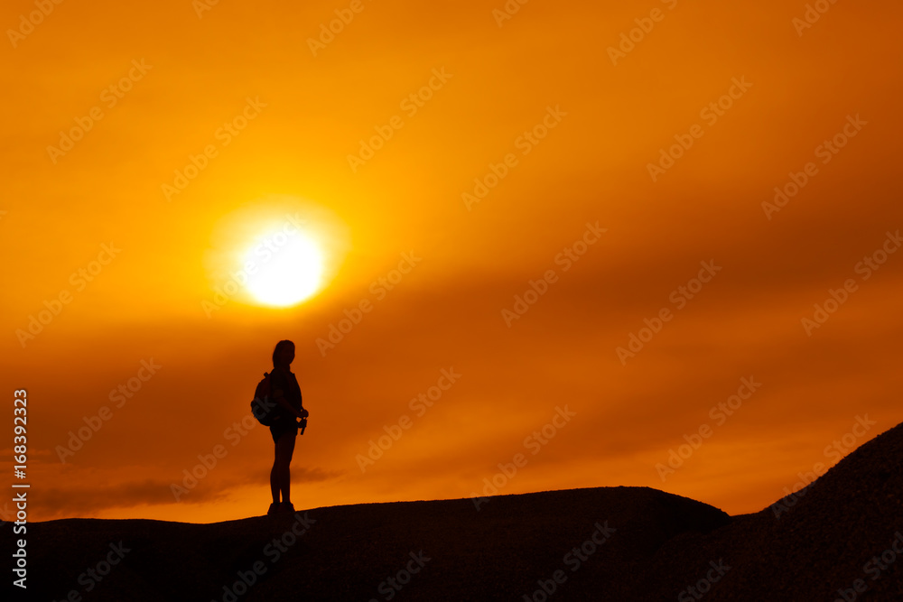 Young girl asian with backpack travel trip stand finish destinations on the mountain looking view sunset silhouette