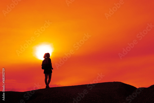 Fototapeta Naklejka Na Ścianę i Meble -  Young girl asian with backpack travel trip stand finish destinations on the mountain looking view sunset silhouette
