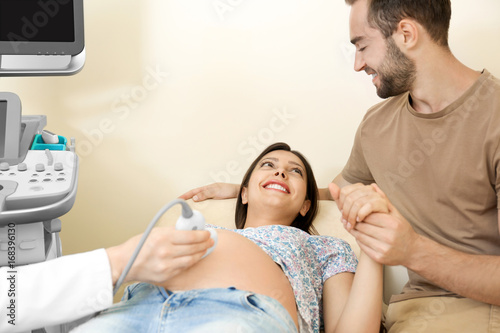 Young pregnant couple under...