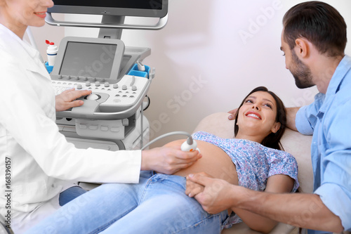 Young pregnant couple under...