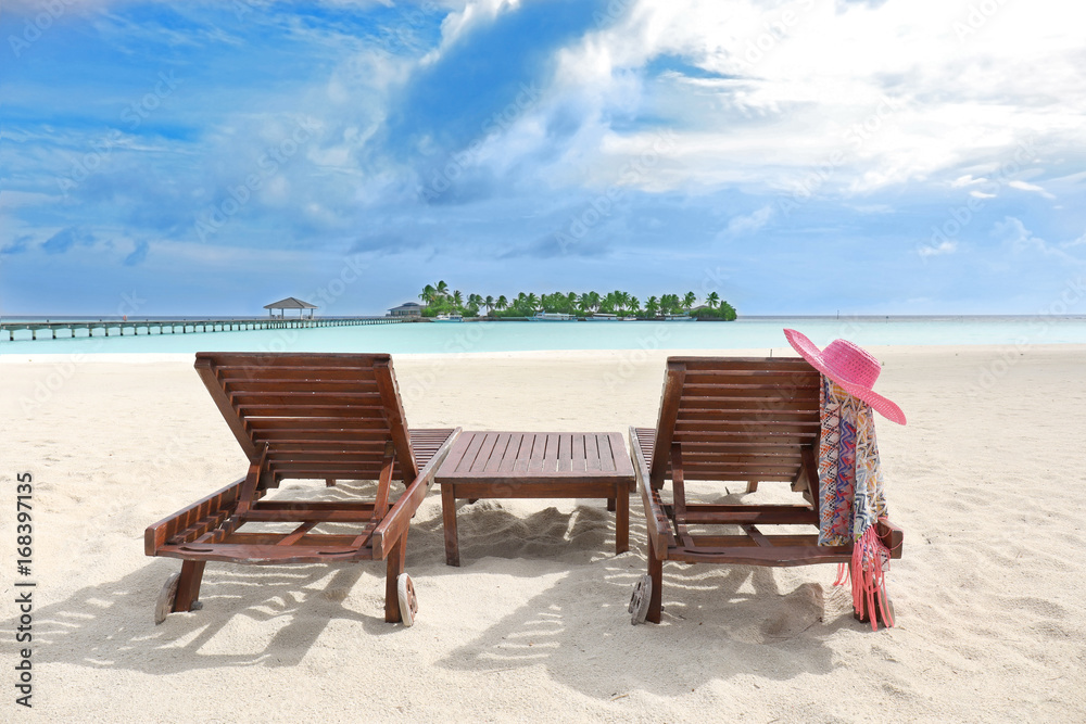 Sun loungers on sea beach at resort