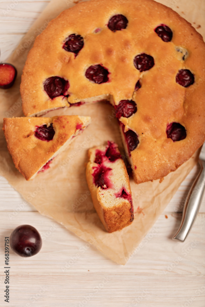 Home plum pie on baking paper. Home plum pie on baking paper.