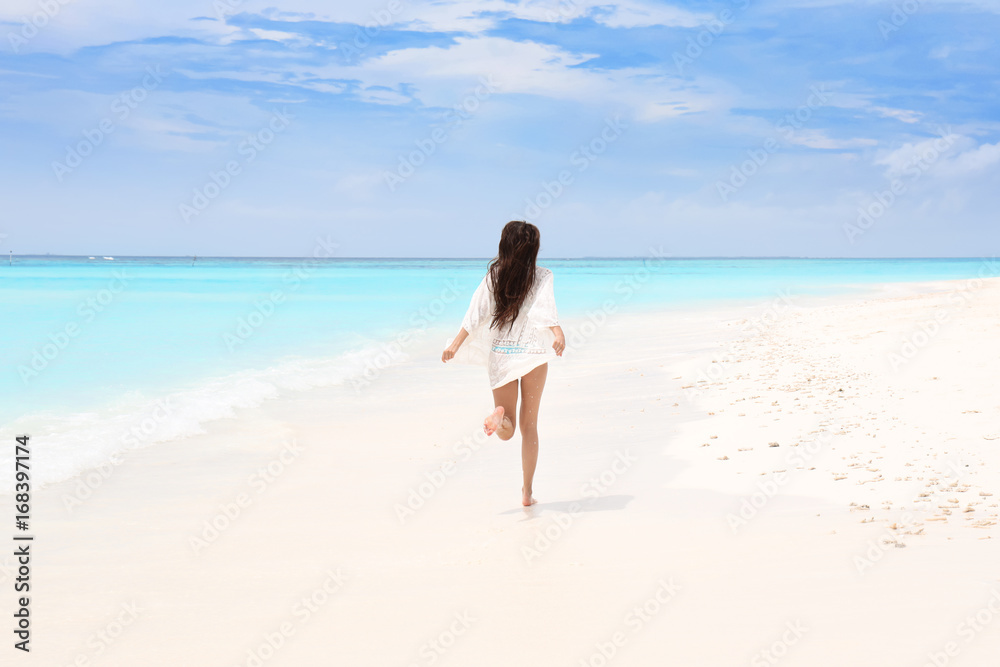 Beautiful young woman on sea beach