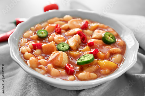 Bowl with delicious turkey chili on kitchen table