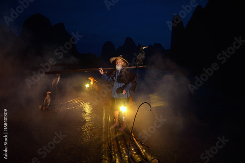 Fisherman of Guilin, Li River and Karst mountains during the blue hour of dawn,Guangxi  China photo