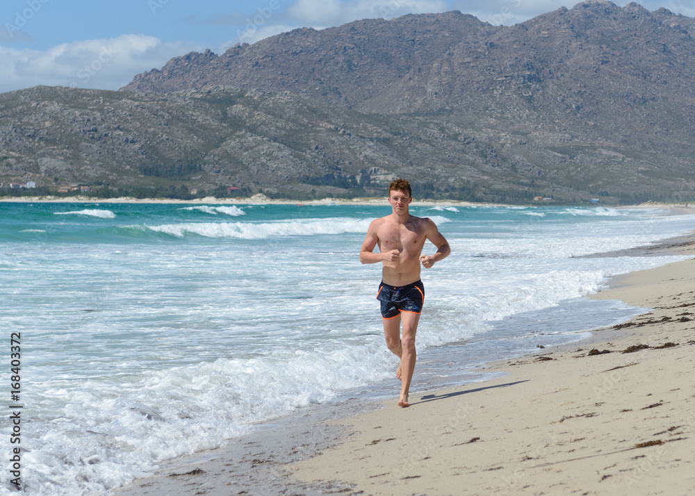 young man jogging on the sea beach