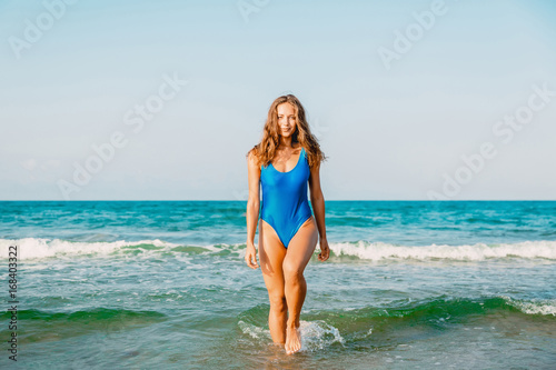 Smiling beautiful woman relax in the sea. Crystal blue sea of tropical beach. Vacation in paradise. Ocean beach relax, travel to Bali