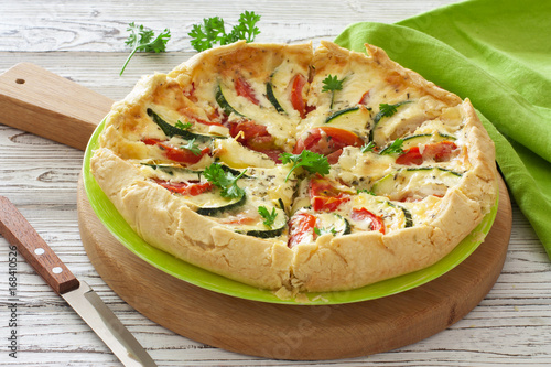 Vegetable rustic pie ( quiche) with tomatoes, zucchini and soft cheese