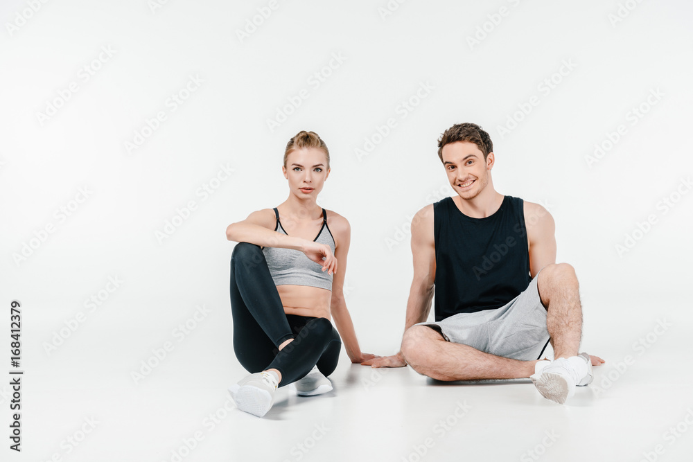 Obraz premium fit couple sitting on floor