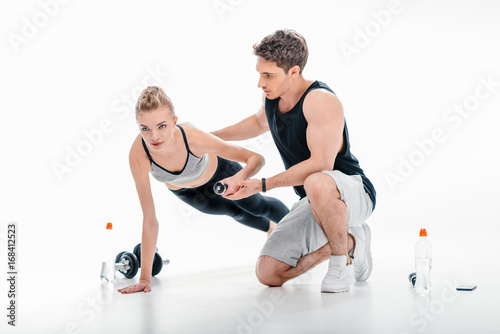 girl doing exercise with trainer