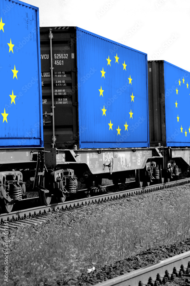 Fototapeta premium Train Freight transportation. Cargo transit. Summer Day. Container textured by flag of the European Union