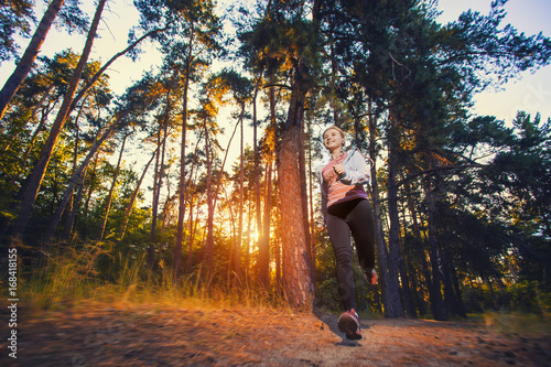 nice young girl on morning jog in a summer forest © Dmytro Titov