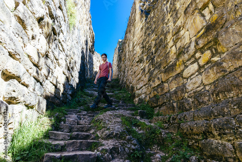young tourist walks trough the preinca ruins of Kuelap near Chachapoyas / Peru/ south america photo