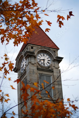 The clock tower of Indiana University in the fall in Bloomington, Indiana with colorful leaves. photo