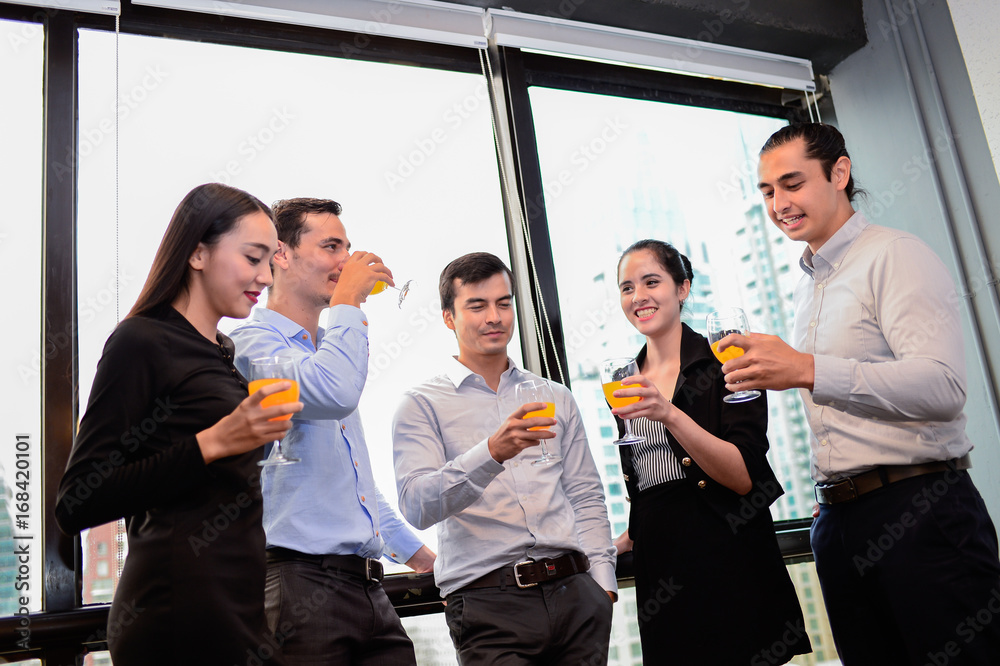 business man are business woman drinking champagne talking and smiling while celebrating in office, successful business concept. business man are business woman drinking champagne talking and smiling while celebrating in office, successful business concept.