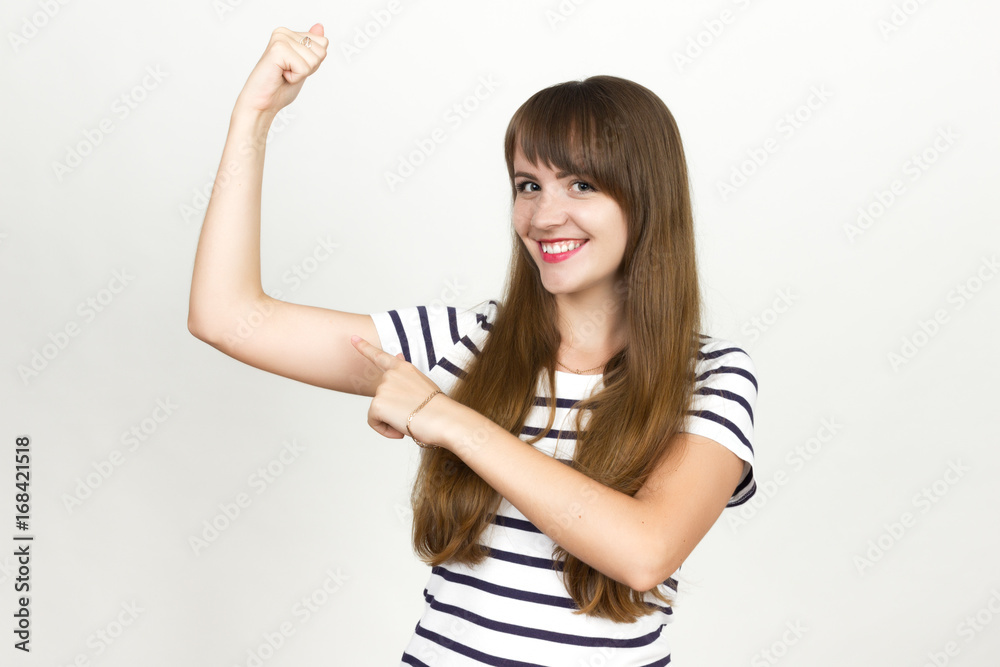 Joyful. Very happy woman points to the muscles Joyful. Very happy woman points to the muscles