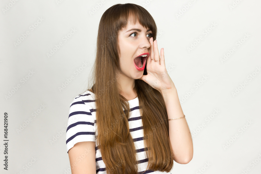 Portrait of a pretty womanscreaming put one hand to her face Portrait of a pretty womanscreaming put one hand to her face