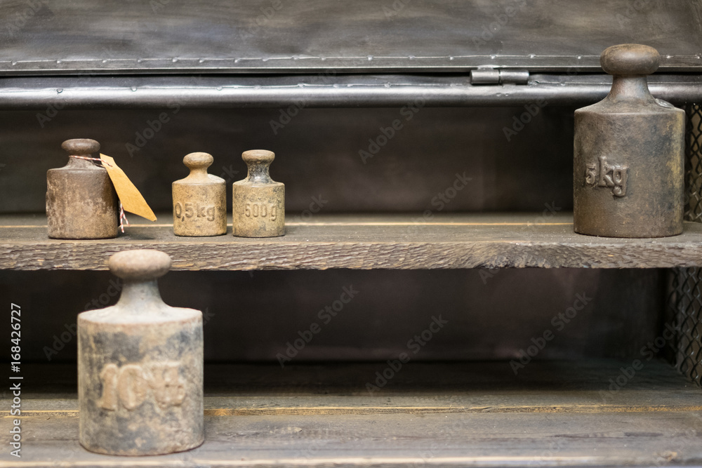old weights  on work bench - vintage kg weights on wooden background