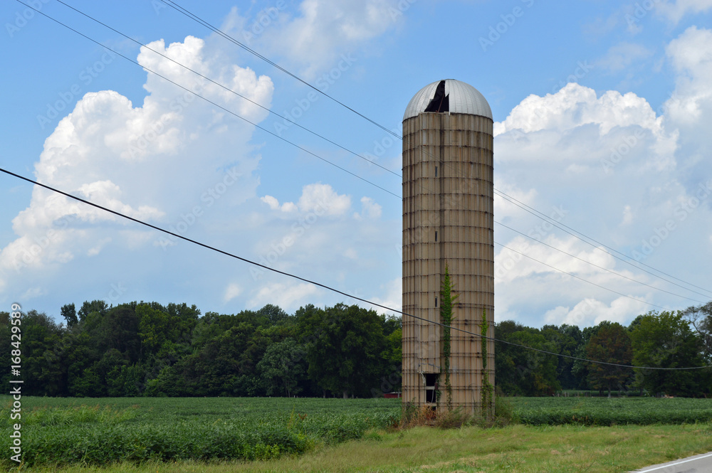 Old rundown silo in a field on a farm