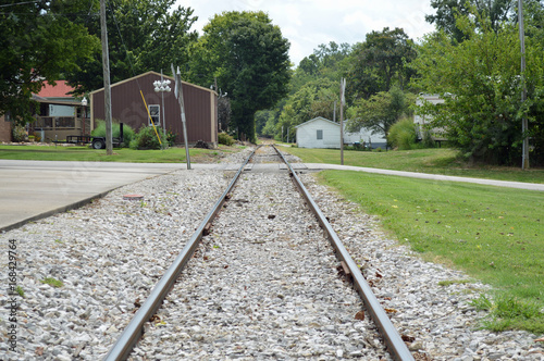 Line perspective of train tracks running through a small town