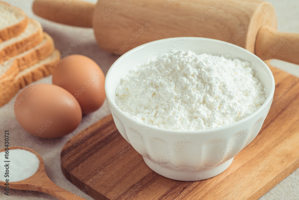 Flour in bowl with eggs and bread