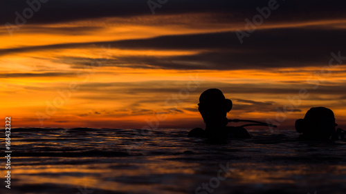 beautiful sky in golden hour when diver floating on the water before start dive