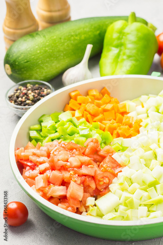 Raw zucchini saute in a skillet. Selective focus, close up.