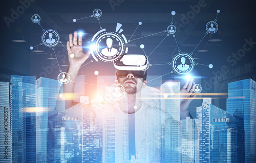 Businessman in VR glasses, network in a city