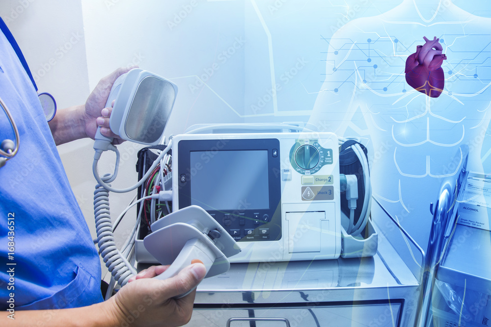 doctor use ekg defibrillators monitor in emergency room Stock Photo